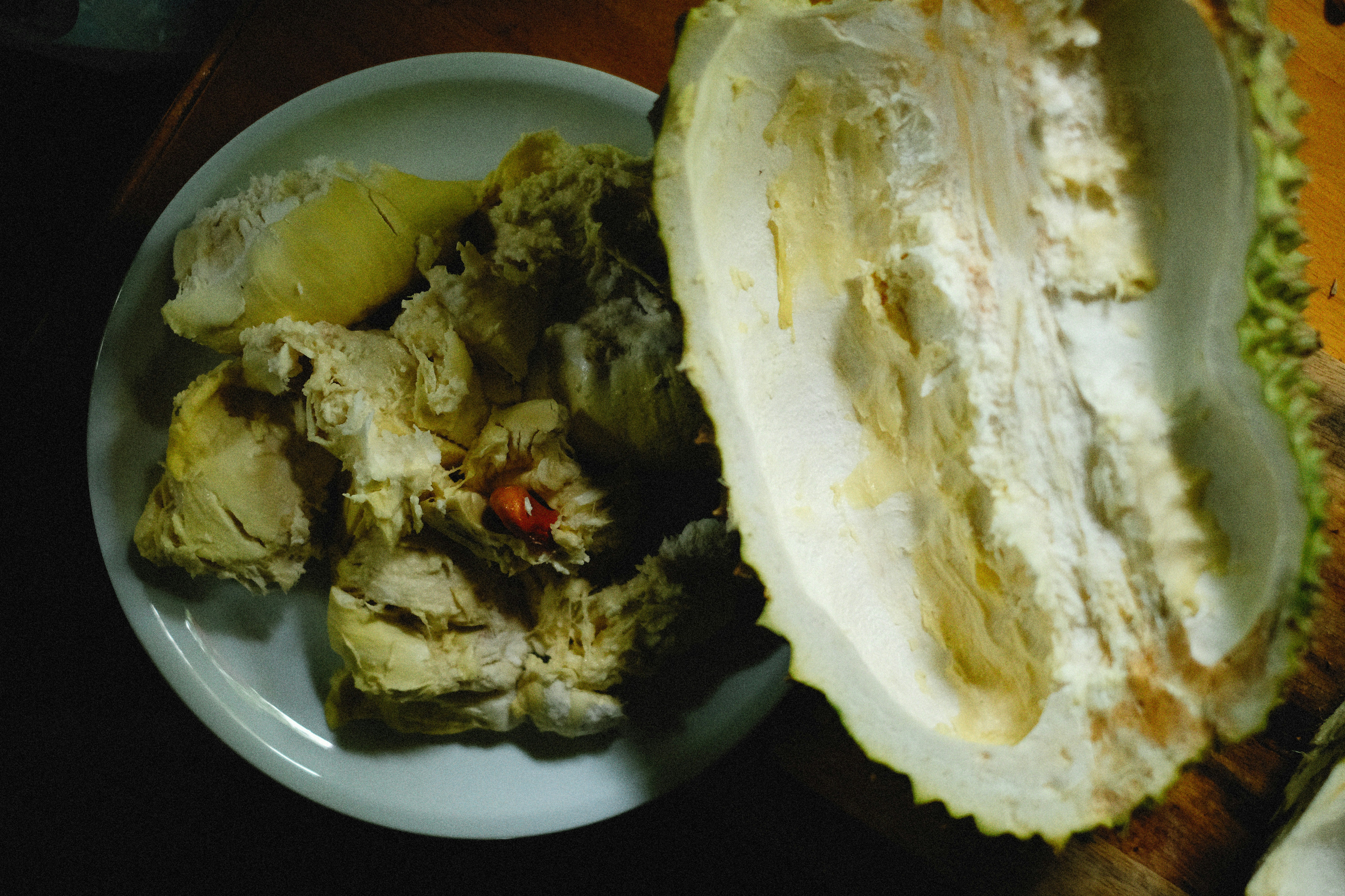 a white plate topped with food on top of a wooden table