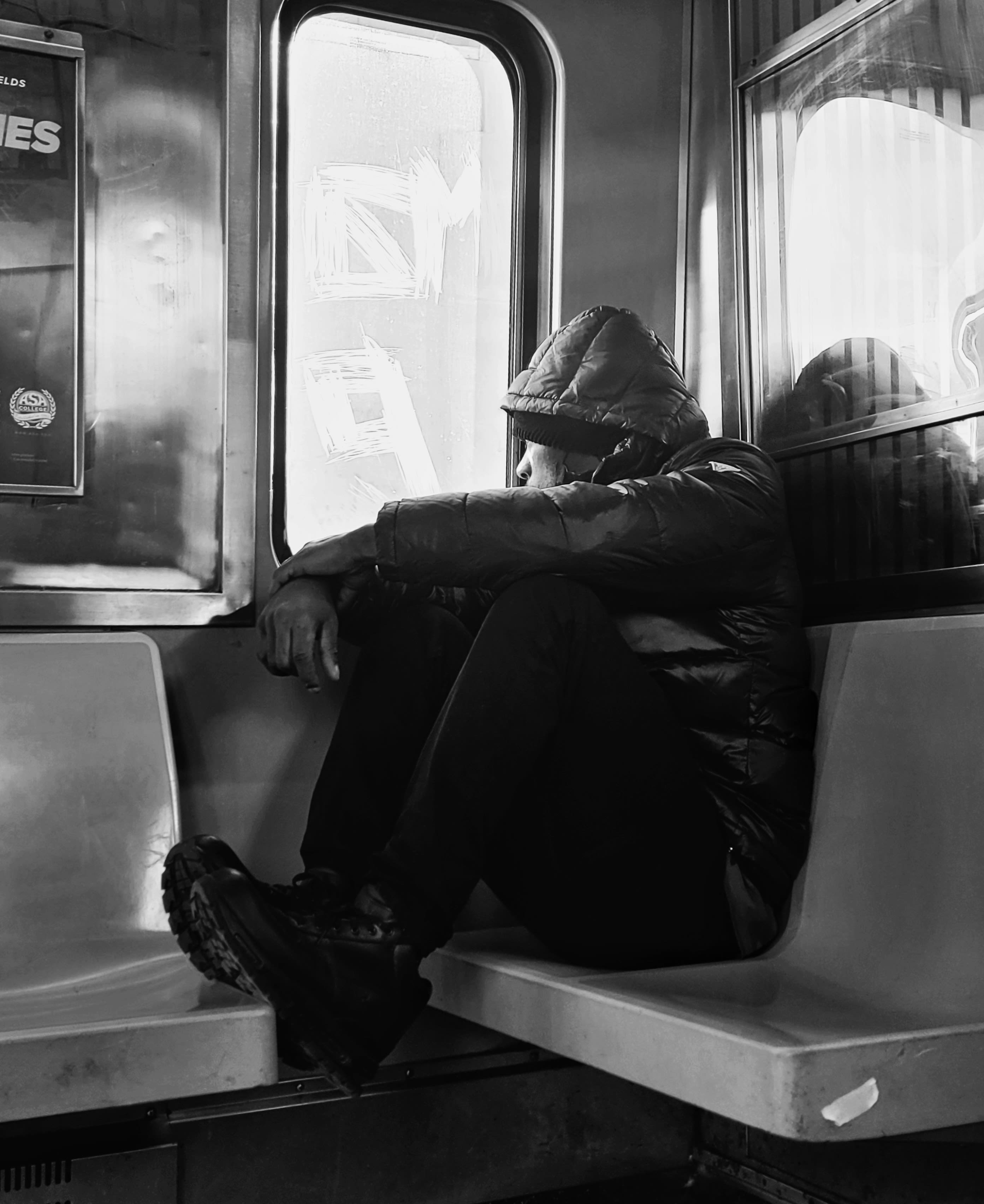 a person sleeping on a subway