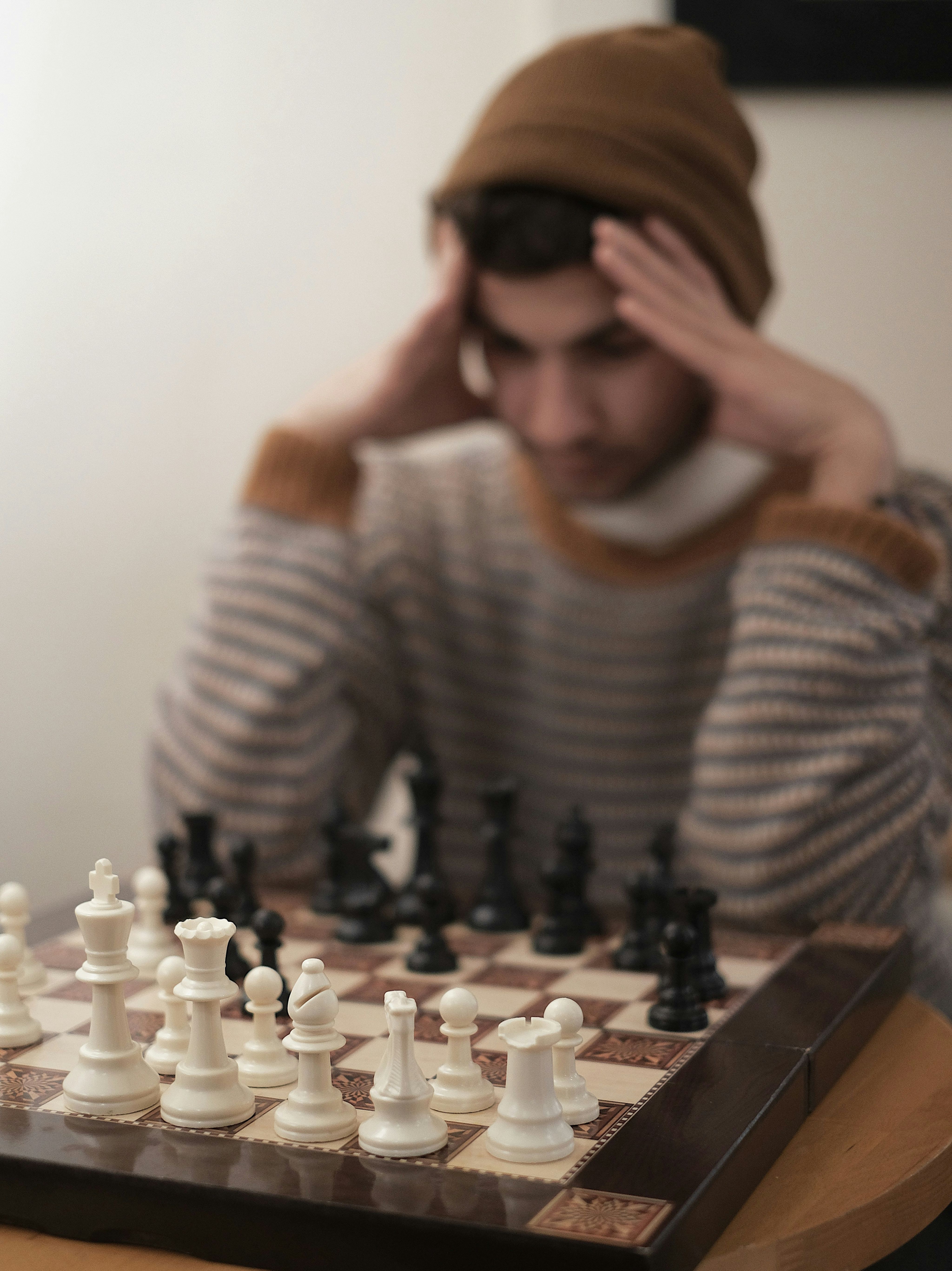 a man sitting at a table with a chess board