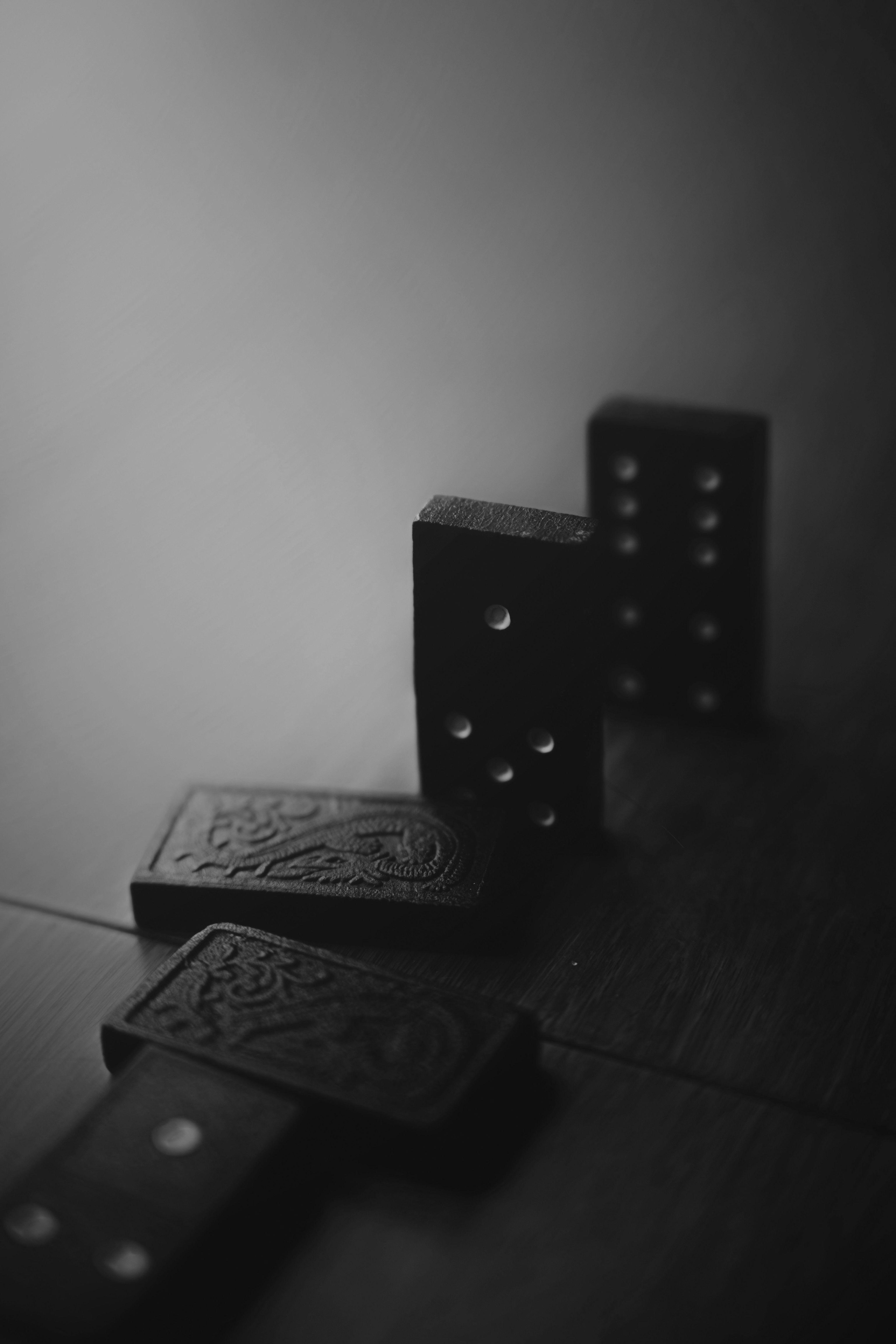 A pair of black dice sitting on top of a wooden table